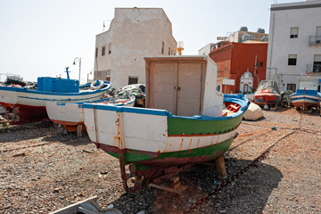 Small fishing boats pulled ashore on the beach in the island of Marettimo, in the Egadi islands in Sicily, Italy.