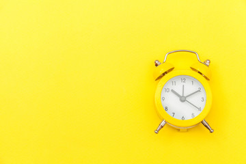 Ringing twin bell vintage classic alarm clock Isolated on yellow colourful trendy modern...