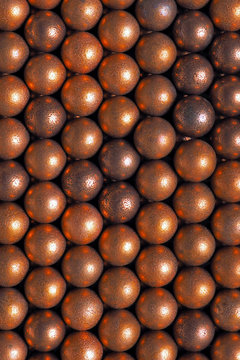 Many balls for shooting from an air gun. Top view from above. Vertical background or wallpaper. Macro