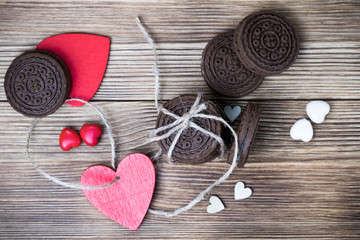 chocolate cookie sandwich on a wooden background. wooden and red hearts. happy Valentine's day. beautiful picture with biscuits. international women day, women's day