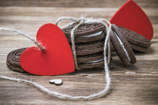 chocolate cookie sandwich on a wooden background. wooden and red hearts. happy Valentine's day. beautiful picture with biscuits. international women day, women's day