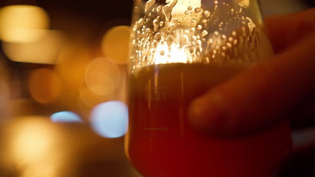 beer glass on table in bar. lights and beautiful bokeh on blurred background