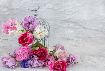 decorative cage and flowers in it: hyacinths and tulips - holiday card