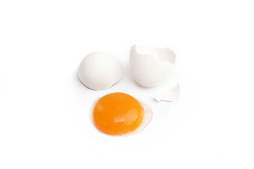 Broken chicken egg isolated on white background. Egg yolk and eggshell. Close up