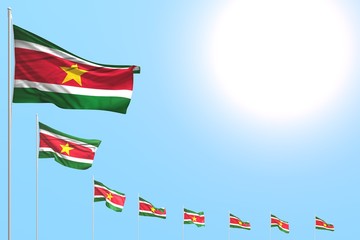 beautiful many Suriname flags placed diagonal on blue sky with place for content - any feast flag 3d illustration..