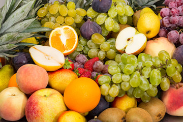 fruits background from fresh juicy fruits apples grapes, pineapple, papaya, pear, peach, figs, strawberries.