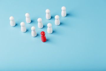 The leader in red leads a group of white employees to victory, HR, Staff recruitment. The concept of leadership.