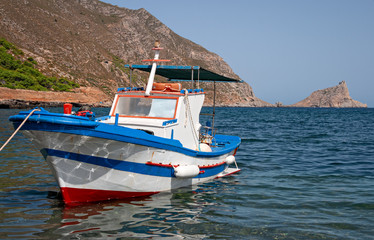 A fishing boat anchored on the shore in the small port of the island of Marettimo, in the Egadi islands in Sicily, Italy.