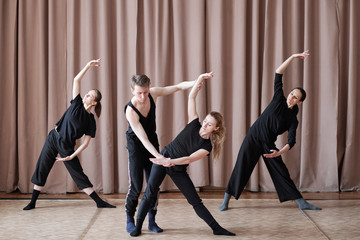 Professional contemporary dancers working on new dance moves in studio