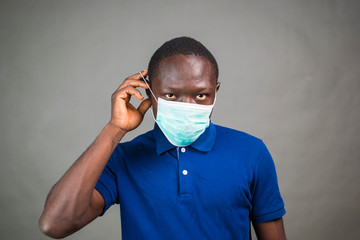 young black man wearing a medical face mask