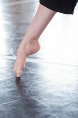 Bare foot of unrecognizable professional contemporary dancer, vertical close up shot