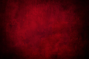 red grunge background or texture with dark vignette borders and spotlight