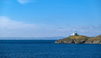Fototapeta na wymiar Greece, Kea Tzia island. Seascape with lighthouse, clear blue sky