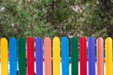 Old colorful decayed wooden fence entrance of the playground