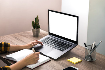 close up hands of a businesswoman, student or freelancer in yellow shirt and white screen on laptop. modern office