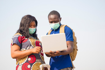 black people, travelers, wearing face masks, standing outdoors