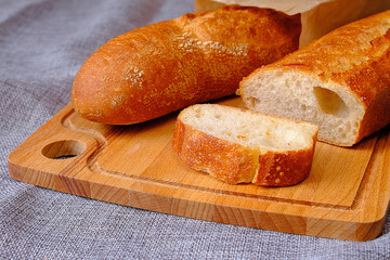 Fresh warm baguette with a crispy crust. Sliced for Breakfast. For the morning sandwich.