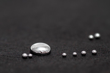 Shiny Mercury drops on a black background