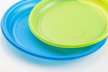 background with copy space of two multi-colored plastic plates