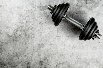 Dumbbell on a neutral background with whitespace