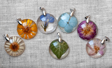 handmade epoxy resin jewelry. pendants. in copper frame. chamomile, calendula, lobelia, hydrangea, rose, delphinium, ivy