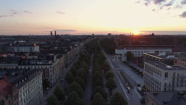 Aerial view of Stockholm Valhallav&auml;gen street in &Ouml;stermalm district at sunset. Drone shot flying over street and buildings, cityscape skyline. Beautiful sky over Capital city of Sweden