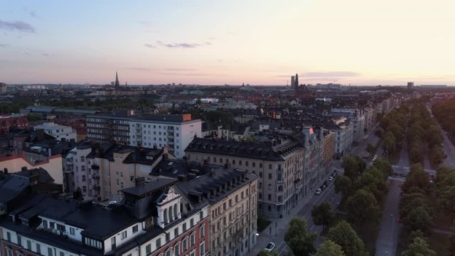 Aerial view of Stockholm cityscape skyline, &Ouml;stermalm district at sunset. Drone shot flying over Valhallav&auml;gen street and buildings. Beautiful sky over Capital city of Sweden