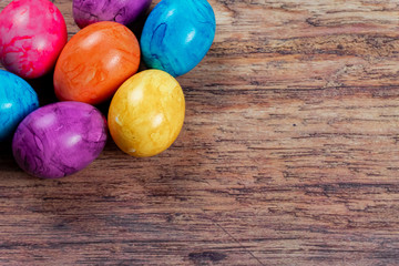 Obraz na płótnie Canvas colored easter eggs on wooden ground