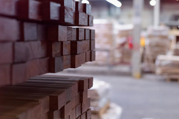 Timber Flooring Factory. Pile of cut wood in factory storage warehouse. Lumber in warehouse.