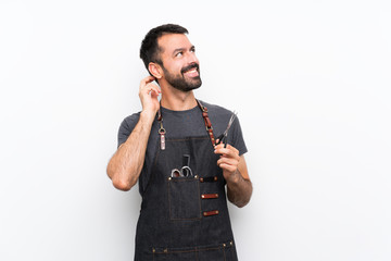 Barber man in an apron thinking an idea