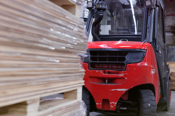 Fototapeta premium Timber Flooring Factory. Pile of cut wood in factory storage warehouse. Lumber in warehouse.