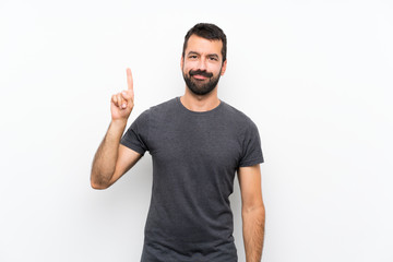Young handsome man over isolated white background showing and lifting a finger in sign of the best