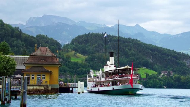 Swiss Flag. Traditional steamboat ship on Lake Lucerne, Swiss Alps.  Luzern beautiful Alpine nature. Switzerland summer luxury tourism, 4k. 