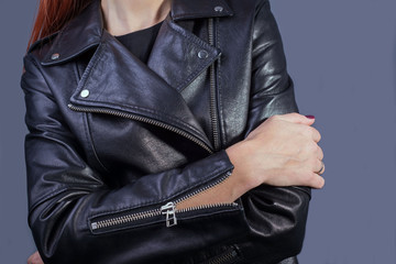 close-up portrait of a girl in a high-quality leather jacket. Rock and roll style in women. Promotional photo of a leather jacket