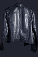 promotional photo for the catalog of a high-quality leather jacket in the style of rock and roll. On a dark gray background