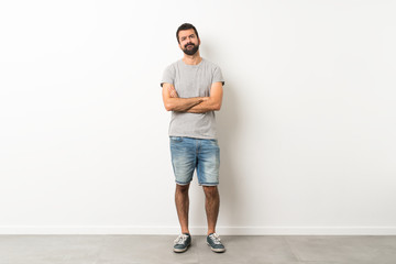 A full-length shot of handsome man with beard feeling upset