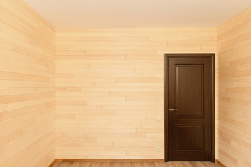 Room interior with a door sheathed by wooden light boards