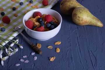 pears, raspberries and granola are on the table