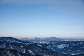 Obraz na płótnie Canvas Winter mountain landscape.Snow mountains overgrown with taiga against a blue sky. Russia. Altai Republic.