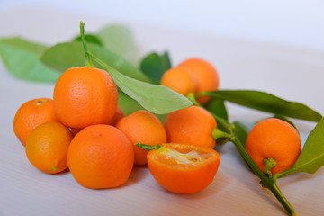 Calamondins on white cutting board