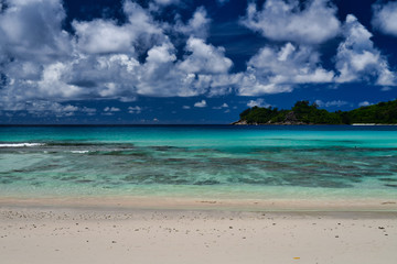 Fototapeta na wymiar Takamaka Beach Mahe Island Seychelles - ocean waves and sky.