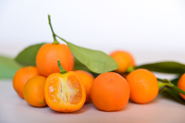 Calamondins on white cutting board