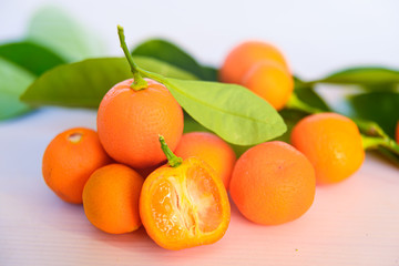 Calamondins on white cutting board