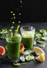 The concept of healthy kitchen. Smoothies with herbs, spinach on a dark background. Background image, copy space