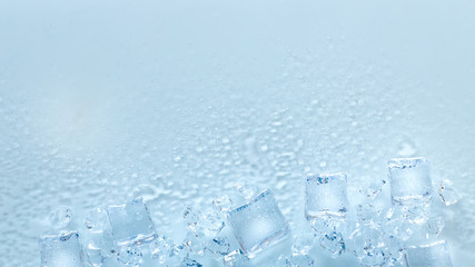 ice cubes, whole and melted on a light background / place for text