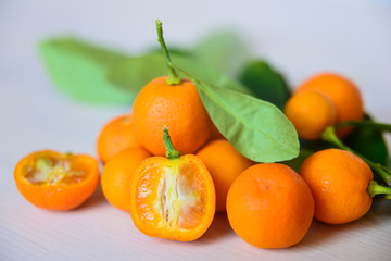 Calamondins on white cutting board