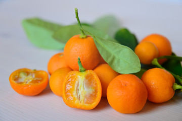 Calamondins on white cutting board