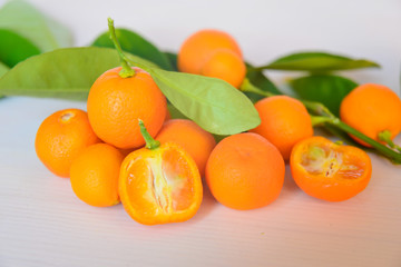 Calamondins on white cutting board