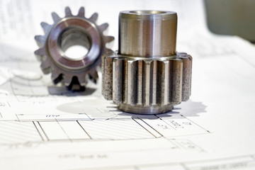 The gear after manufacturing on the gear cutter lies on the technical drawing.