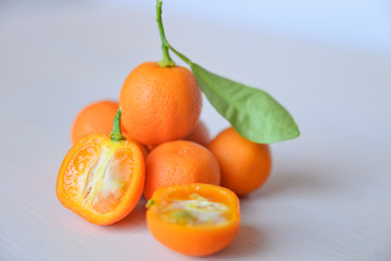 Calamondins on white cutting board